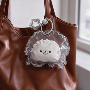 Brown-and-white dumpling bear squishy displayed as a small bag charm.