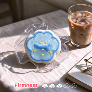 Blue frosted snowman squishy on a clear plate beside a drink.