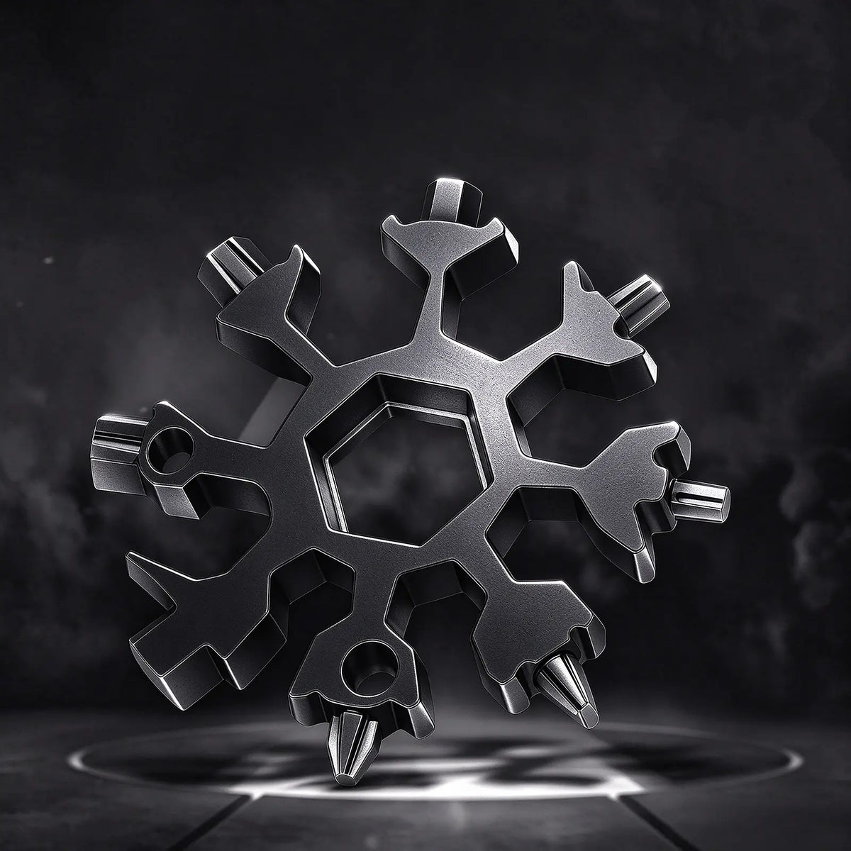 Gift FlakeWrench snowflake multi-tool, matte black metal snowflake shaped wrench with hex sockets and screwdriver tips, all-in-one portable EDC tool on dark moody background