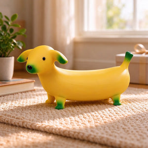 Yellow banana-shaped dog squishy displayed on a woven tabletop.