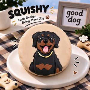 Hand-painted Rottweiler squishy toy, cute Rottweiler dog portrait with gold collar on soft round fidget toy, light beige glossy surface on display plate
