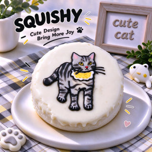 Hand-painted Tabby Cat squishy toy, cute tabby cat portrait with yellow ruffle bib on soft round fidget toy, white glossy surface with gray black stripes on display plate